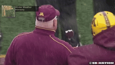 Man In Maroon Jacket With Letter A Eating Football GIF