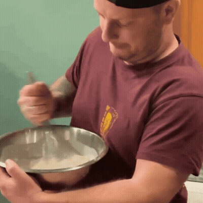 Man In Maroon Shirt Mixing In Silver Bowl GIF