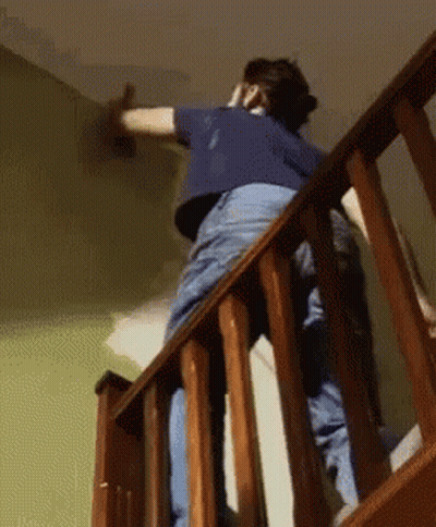 Man In Maroon Shirt Painting On Easel GIF