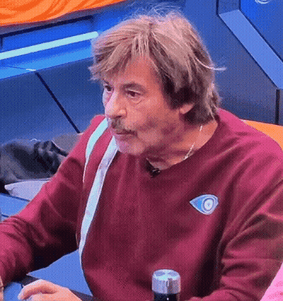 Man In Maroon Sweater With Blue Eye GIF