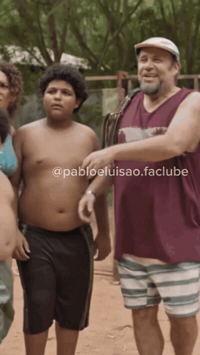 Man In Maroon Tank Top Next To Boy In Striped Shorts GIF