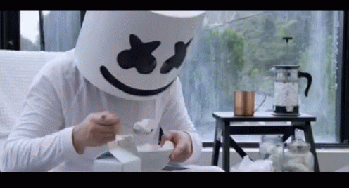 Man In Marshmallow Mask Eating Ice Cream GIF