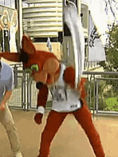 Man In Mascot Costume Standing Next To Mascot GIF