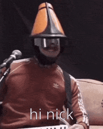 Man In Mask And Cone Hat Playing Keyboard GIF