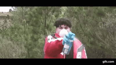 Man In Mask And Gloves Holding Spray Bottle Pointing At Camera GIF