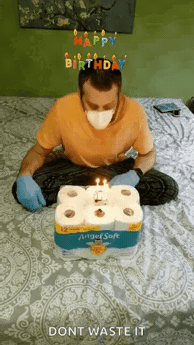 Man In Mask And Gloves With Toilet Paper Cake GIF