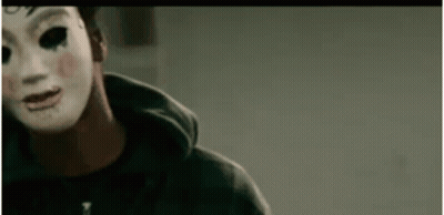 Man In Mask And Hoodie Looking At Camera GIF