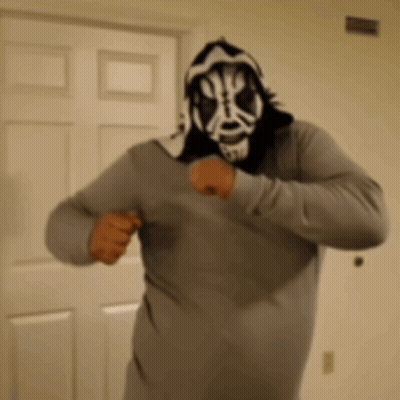 Man In Mask And Hoodie Standing In Front Of Door GIF