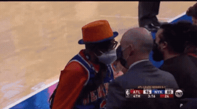 Man In Mask And Orange Hat Talking To Referee GIF