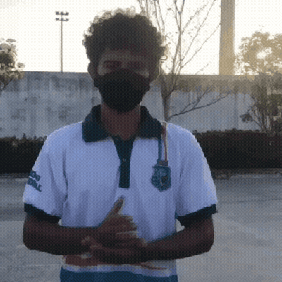 Man In Mask And Polo Shirt With Medal GIF