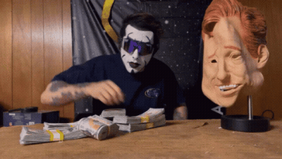 Man In Mask And Sunglasses Next To Money GIF