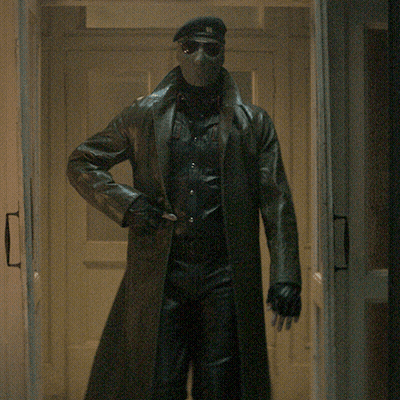 Man In Mask And Sunglasses Walking Through Hallway GIF