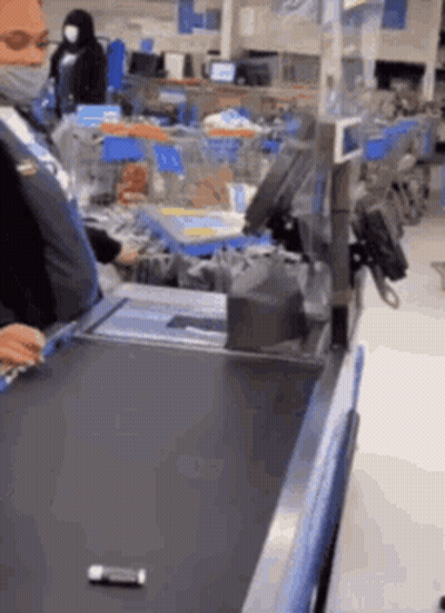Man In Mask At Checkout Counter GIF