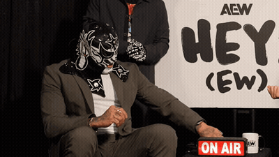 Man In Mask By Sign Saying Hey (Ew) GIF