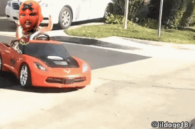 Man In Mask Driving Toy Car On Street GIF