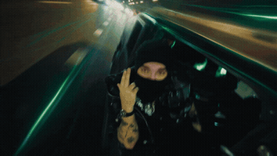 Man In Mask Giving Middle Finger Blurry Photo GIF