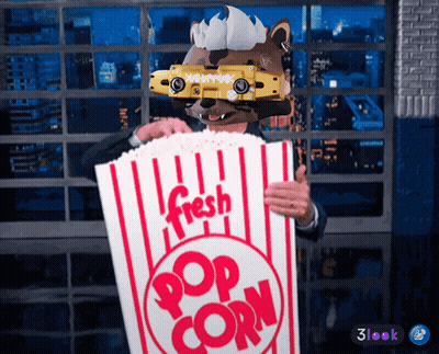 Man In Mask Holding Bag Of Popcorn GIF