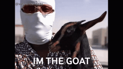 Man in Mask Holding Goat Saying Im the Goat