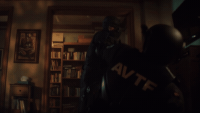 Man In Mask Holding Gun With AVTF On Shirt GIF