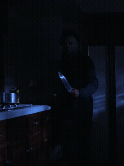 Man In Mask Holding Large Knife GIF