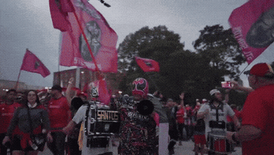 Man In Mask Holding Megaphone Saying Santos GIF