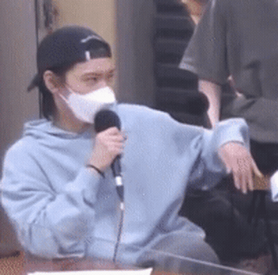 Man In Mask Holding Microphone GIF