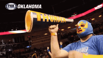 Man In Mask Holding Oklahoma Megaphone GIF