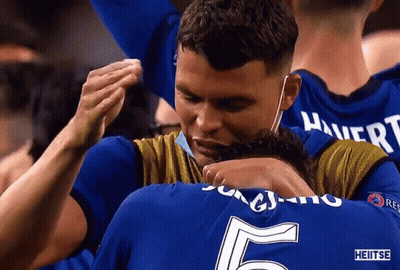 Man In Mask Hugging Man With Number 5 Jersey GIF