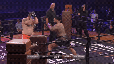 Man In Mask Hugging Wrestler In Chicago Shirt GIF