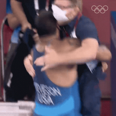 Man In Mask Hugging Wrestler With Chicago Shirt GIF