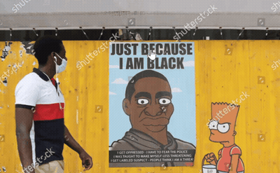 Man In Mask In Front Of Bart Simpson Poster Saying Just Because I Am Black GIF