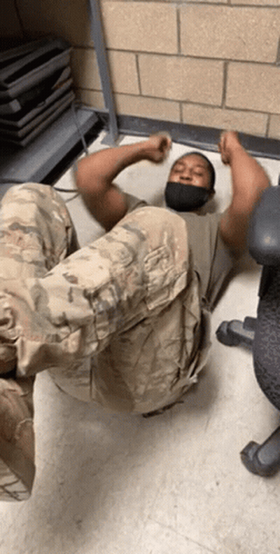 Man In Mask Laying On Floor With Legs Up GIF