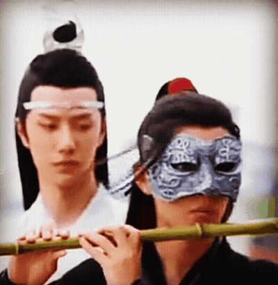 Man In Mask Playing Flute GIF