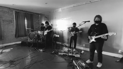 Man In Mask Playing Guitar At Microphone GIF