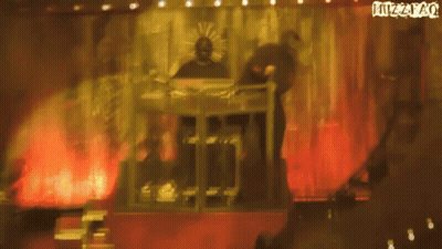 Man In Mask Playing Keyboard On Stage With Juzzpao Sign GIF