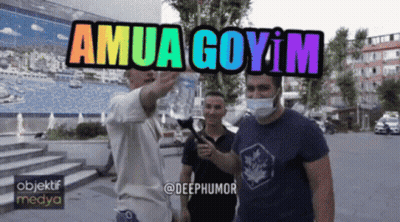 Man In Mask Pointing At Sign Saying Amua Goyim GIF