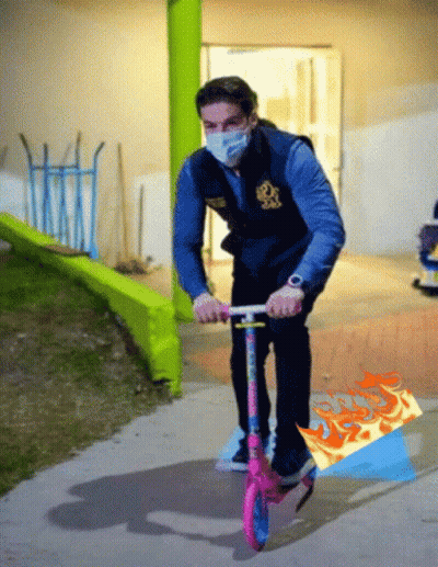 Man In Mask Riding Pink Scooter GIF