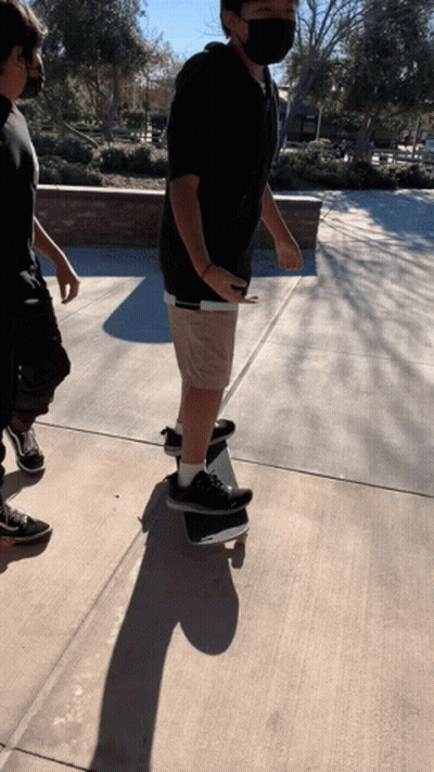 Man In Mask Riding Skateboard GIF