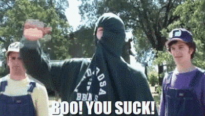 Man In Mask Says Boo You Sucks Beside Two Men GIF
