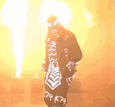 Man In Mask Standing By Ground Fire GIF