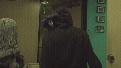 Man In Mask Standing In Front Of Door GIF