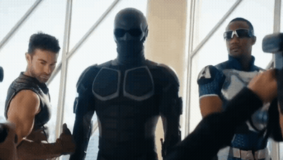 Man In Mask Standing Next To Two Men GIF