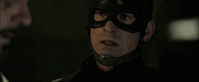 Man in Mask Talking to Another Man in Dark Room