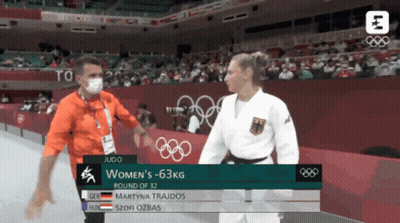 Man In Mask Talking To Woman In Judo Match GIF