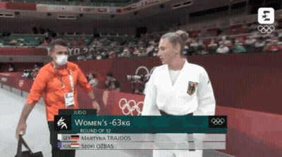Man In Mask Talking To Woman In White Uniform GIF