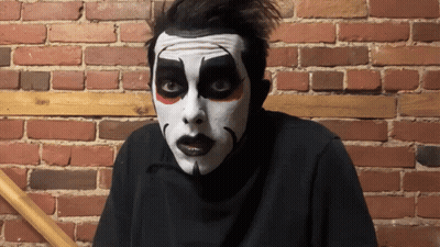 Man In Mask With A Standing Next To Man In Cape GIF