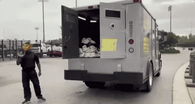 Man In Mask With Megaphone In Front Of Truck GIF