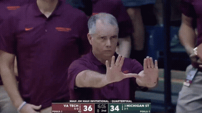 Man In Maui Jim Maui Invitational Shirt In Front Of Scoreboard GIF