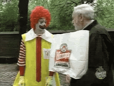 Man In McDonald's Costume Holding Wendy's Hamburgers GIF