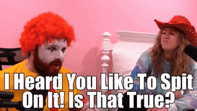 Man In McDonald's Wig Talking To Woman In Cowboy Hat GIF